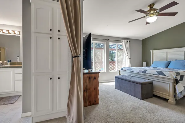 a bedroom with a large bed and a flat tv screen
