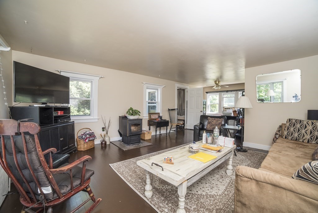 109 Hinsdale Road Northfield, MA 01360 - Photo 2 of 42 a living room with furniture a flat screen tv and a table