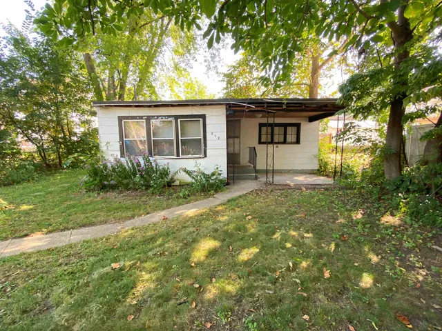 a view of backyard of house with green space