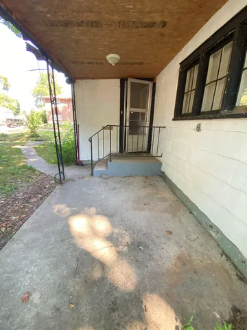 a view of an empty room with floor to ceiling windows