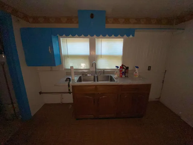 a room with wooden floor and furniture