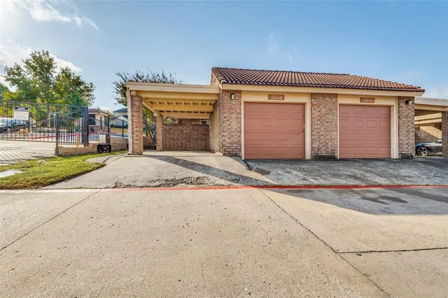 a view of a room with wooden floor and a ceiling fan