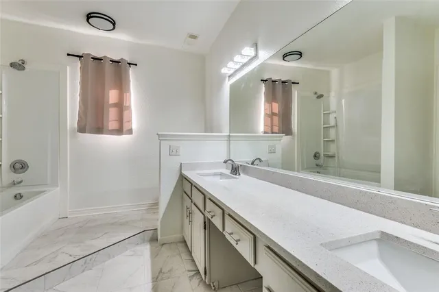 a view of a house with a small yard and wooden fence