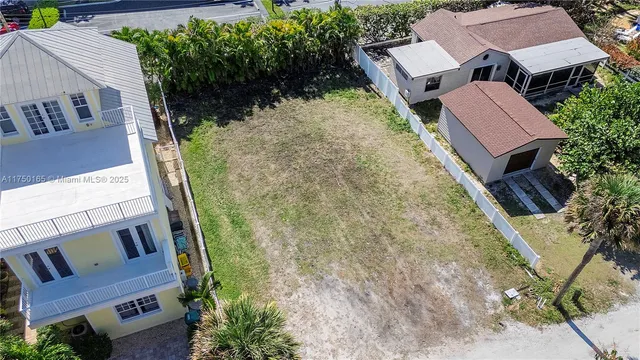 an aerial view of multiple houses with yard