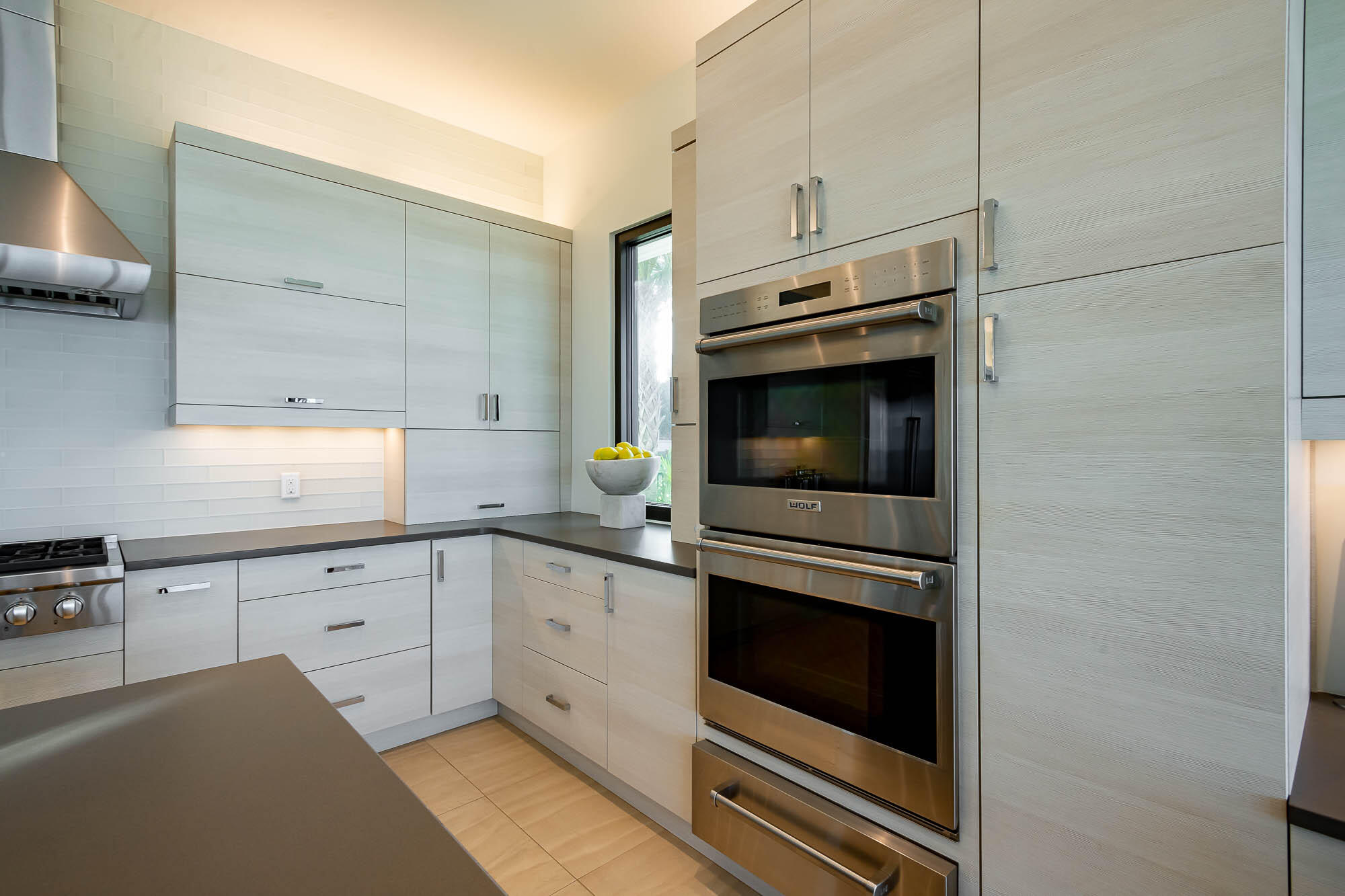 59 Pelican Circle Seacrest, FL 32461 - Photo 32 of 122 a kitchen with granite countertop white cabinets and white appliances