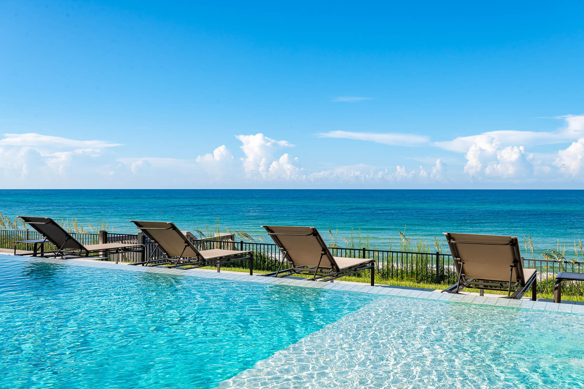 59 Pelican Circle Seacrest, FL 32461 - Photo 51 of 122 a view of a swimming pool with lawn chairs