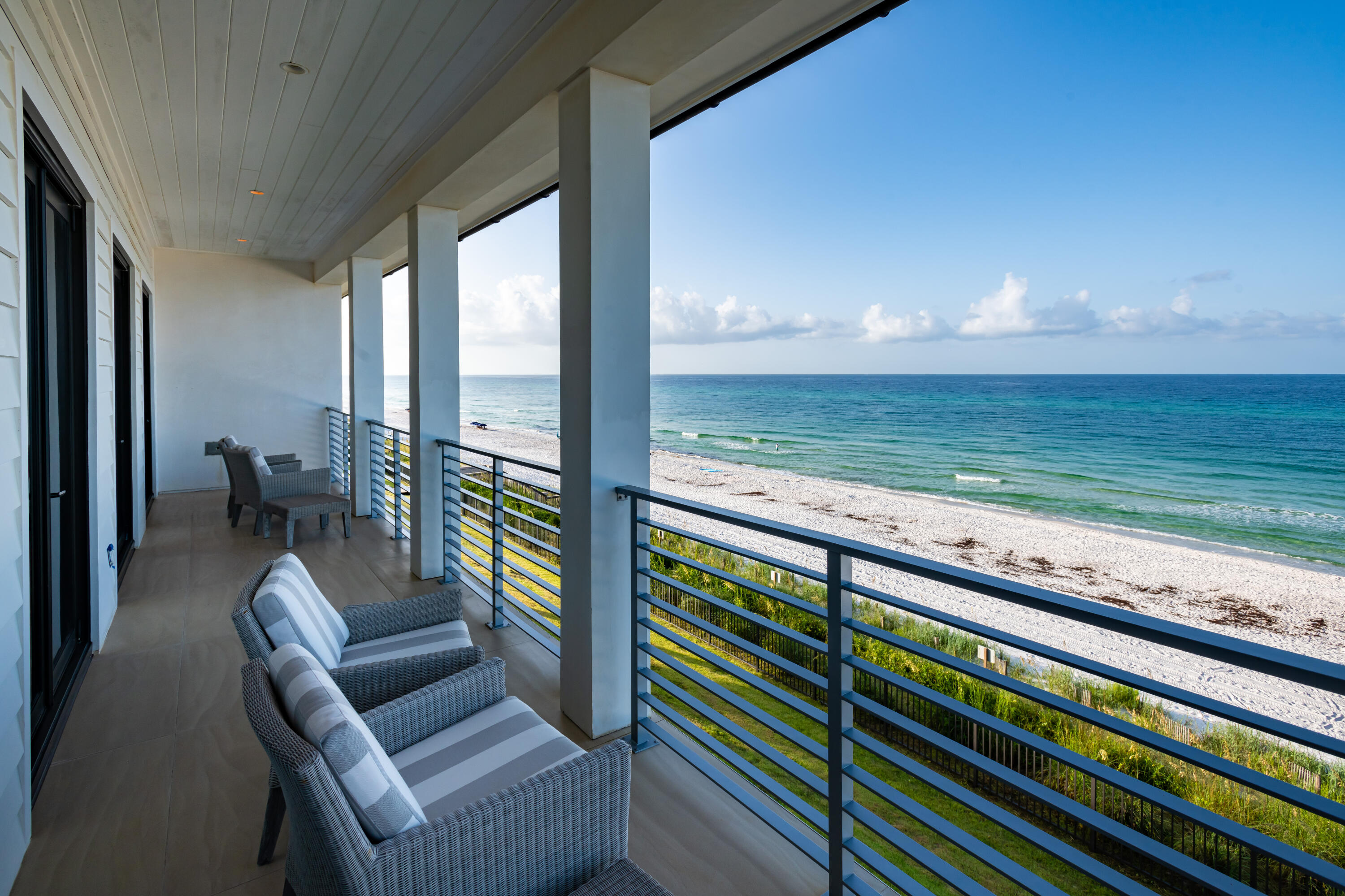 59 Pelican Circle Seacrest, FL 32461 - Photo 87 of 122 a view of a balcony with chair and floor to ceiling window