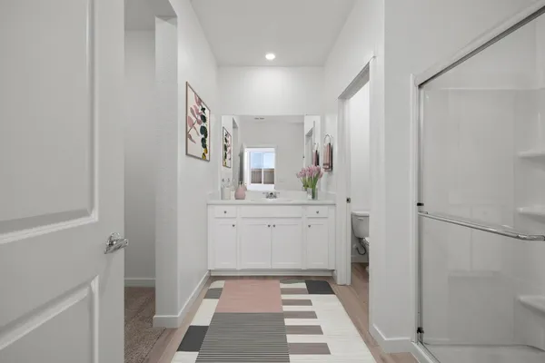a bathroom with a sink a mirror and a shower