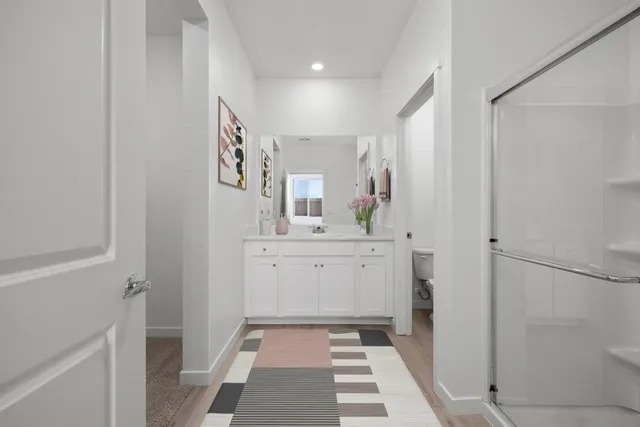 a bathroom with a sink a mirror and a shower