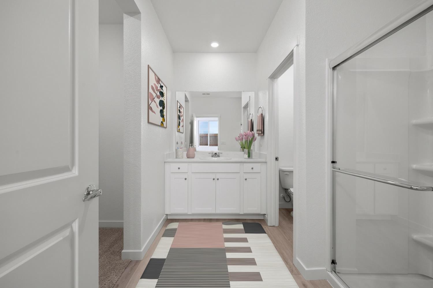 829 Chatham Lane Patterson, CA 95363 - Photo 11 of 16 a bathroom with a sink a mirror and a shower