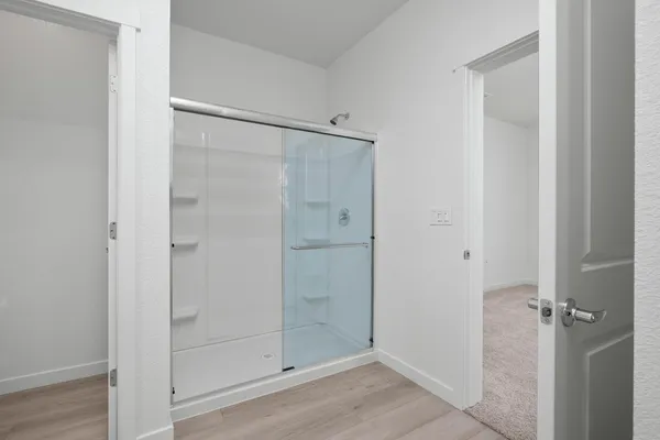 a bathroom with a glass shower door