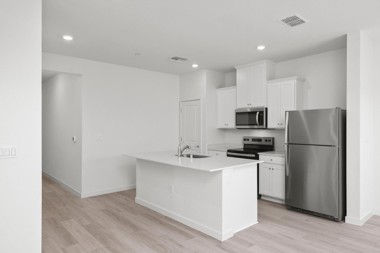 829 Chatham Lane Patterson, CA 95363 - Photo 3 of 16 a kitchen with stainless steel appliances a refrigerator stove microwave and sink