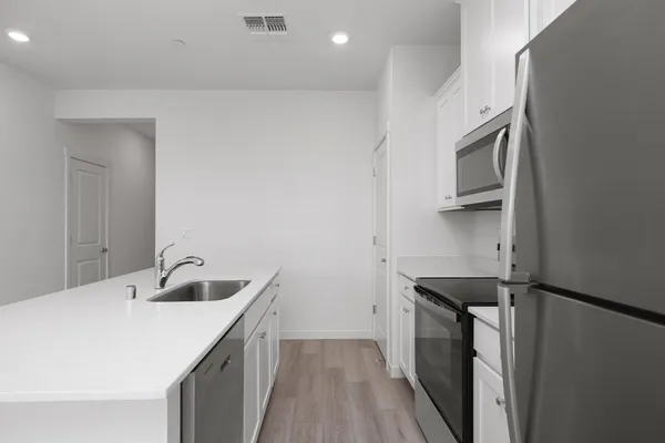 a kitchen with a sink and cabinets