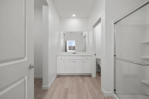 a bathroom with a sink a mirror and a shower