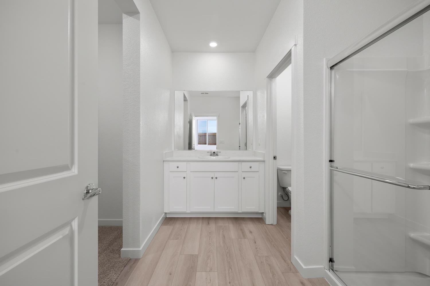 829 Chatham Lane Patterson, CA 95363 - Photo 10 of 16 a bathroom with a sink a mirror and a shower