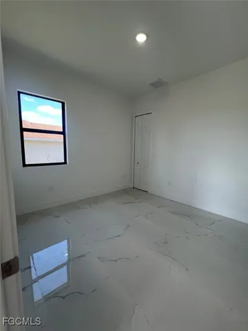 a bathroom with a toilet a sink a mirror and vanity