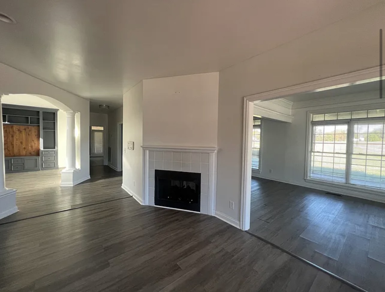 5465 Burnt Knob Road Murfreesboro, TN 37129 - Photo 4 of 14 an empty room with wooden floor and fireplace