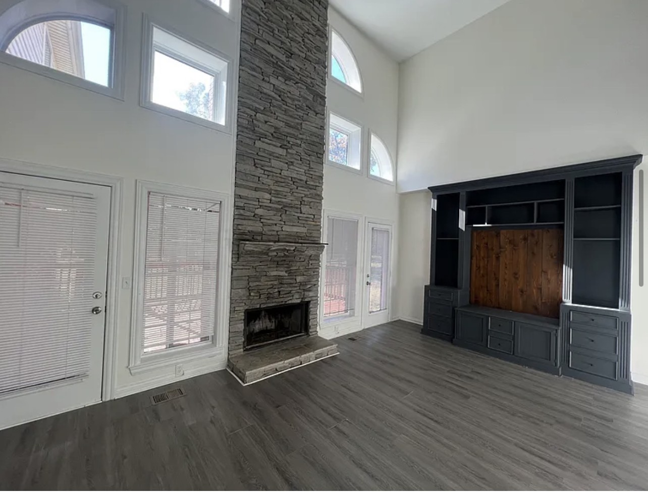 5465 Burnt Knob Road Murfreesboro, TN 37129 - Photo 6 of 14 an empty room with wooden floor fireplace and windows