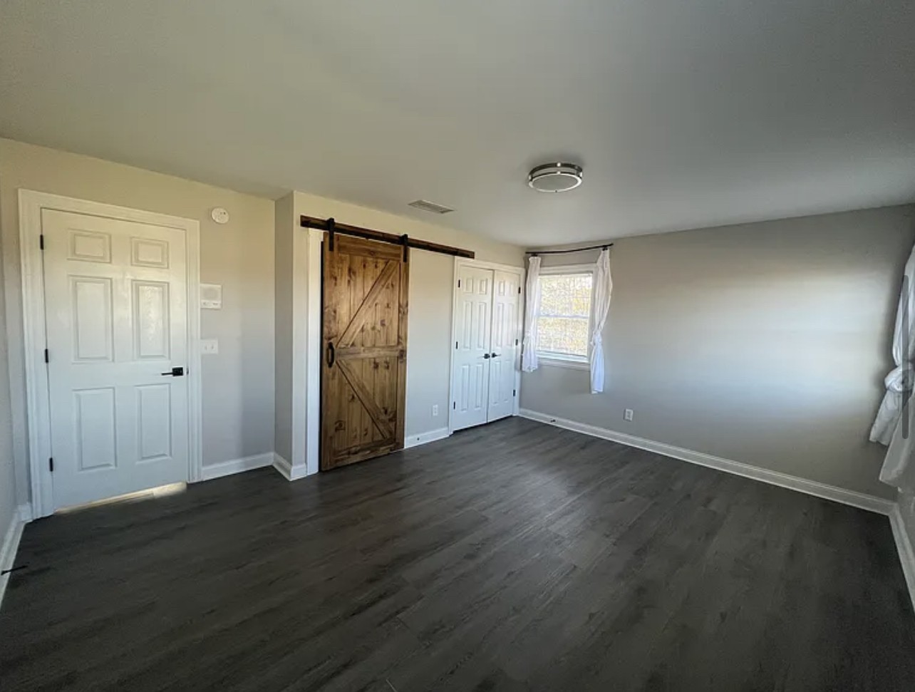 5465 Burnt Knob Road Murfreesboro, TN 37129 - Photo 7 of 14 an empty room with wooden floor and windows