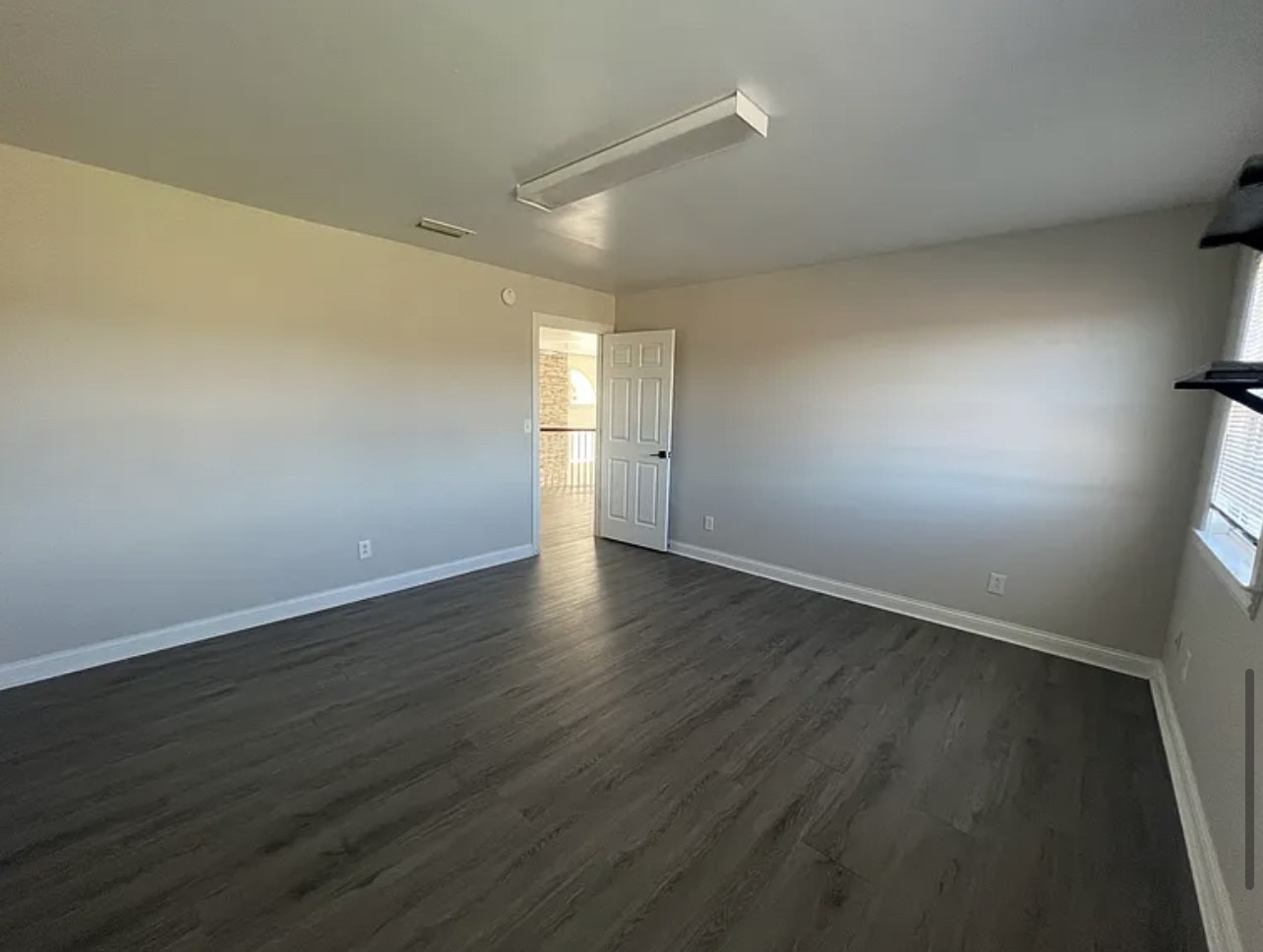 5465 Burnt Knob Road Murfreesboro, TN 37129 - Photo 10 of 14 a view of an empty room with wooden floor and a window