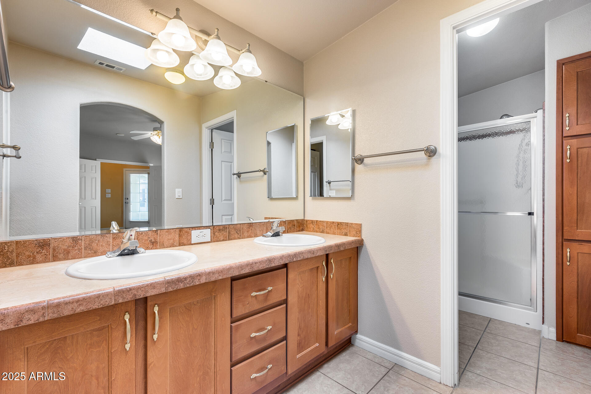 3301 South Goldfield Road, Unit 1043 Apache Junction, AZ 85119 - Photo 12 of 36 a bathroom with a granite countertop sink a large mirror and a shower