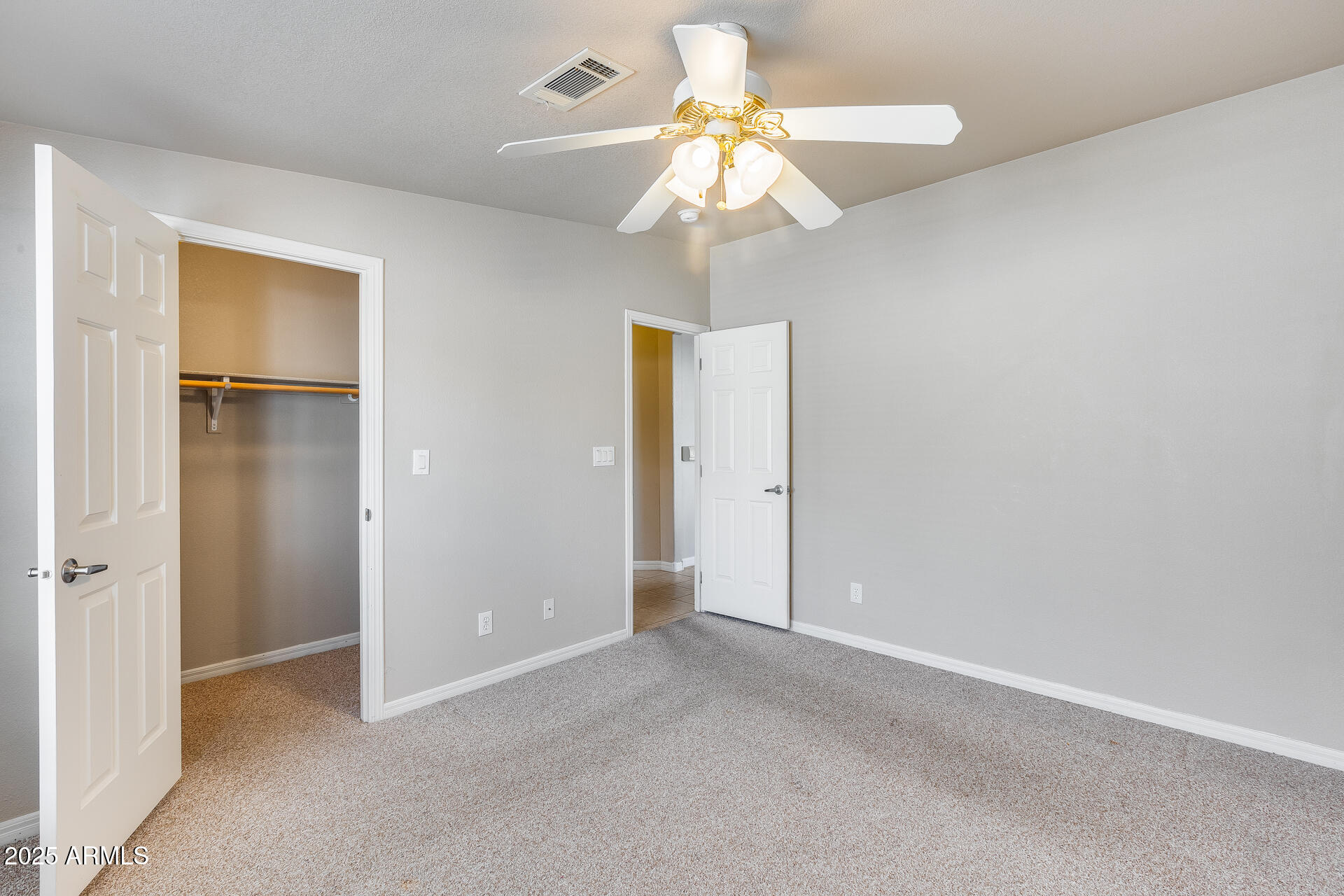 3301 South Goldfield Road, Unit 1043 Apache Junction, AZ 85119 - Photo 18 of 36 a view of an empty room with a chandelier fan