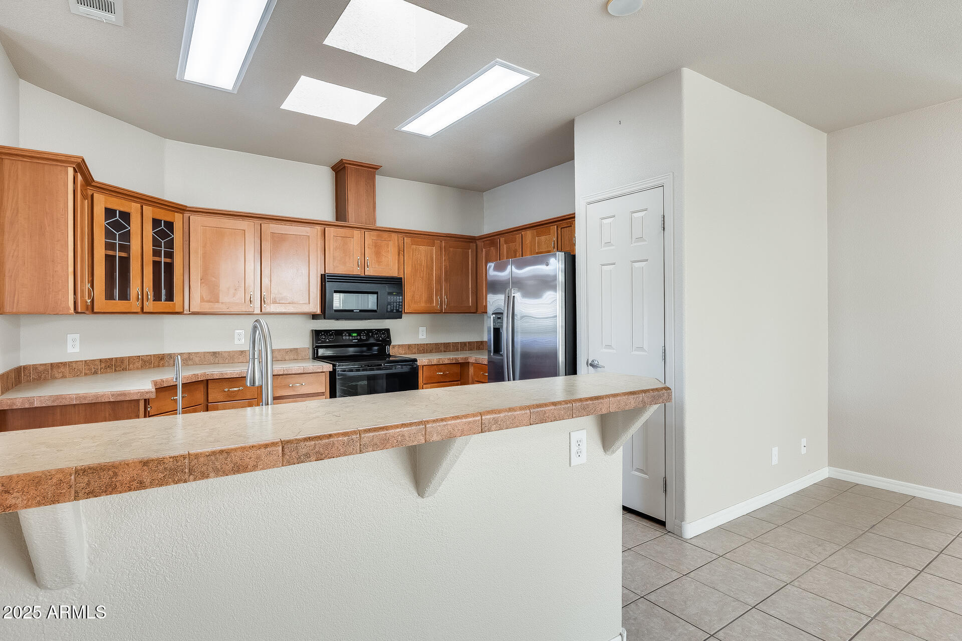 3301 South Goldfield Road, Unit 1043 Apache Junction, AZ 85119 - Photo 29 of 36 a kitchen with stainless steel appliances granite countertop a refrigerator and a sink