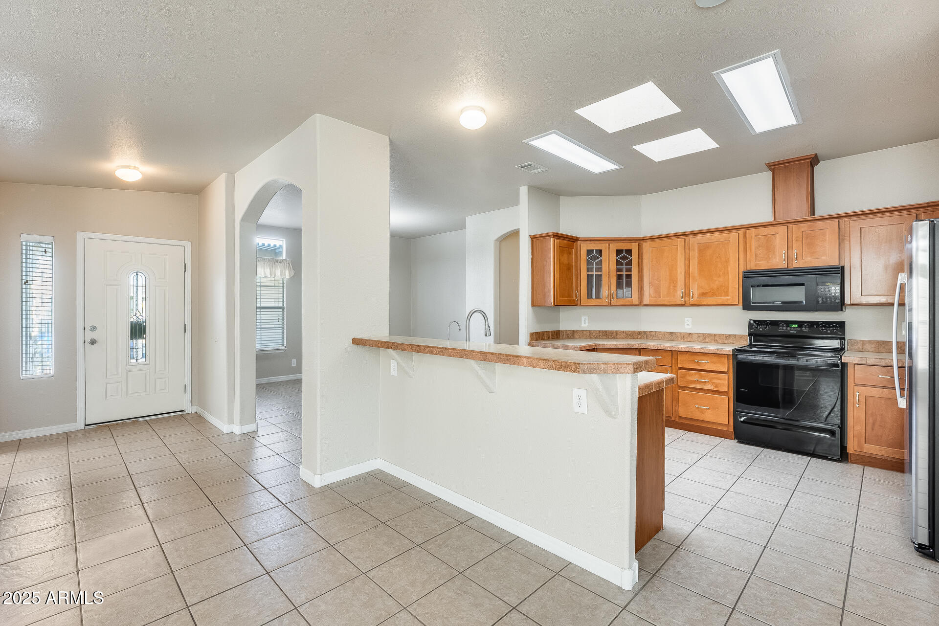 3301 South Goldfield Road, Unit 1043 Apache Junction, AZ 85119 - Photo 3 of 36 a kitchen with stainless steel appliances granite countertop a refrigerator and a stove