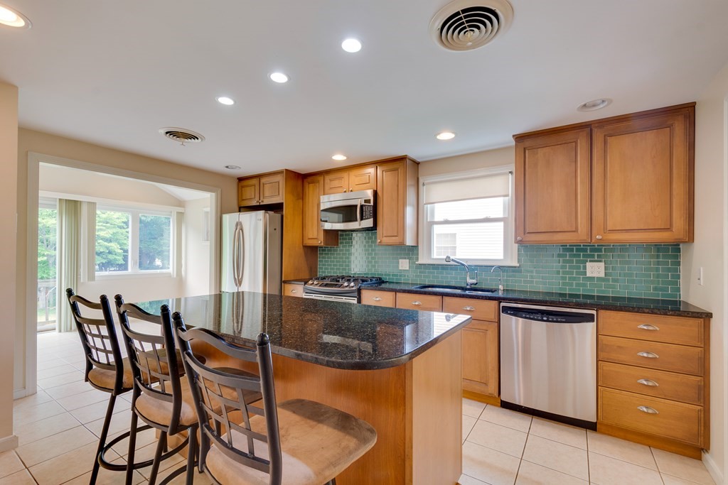 17 Mark Lee Road Needham, MA 02494 - Photo 10 of 24 a kitchen with granite countertop lots of counter top space cabinets and stainless steel appliances