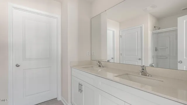 a bathroom with a double vanity sink and a mirror