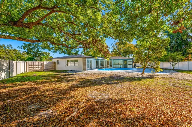 a view of house with outdoor space and swimming pool