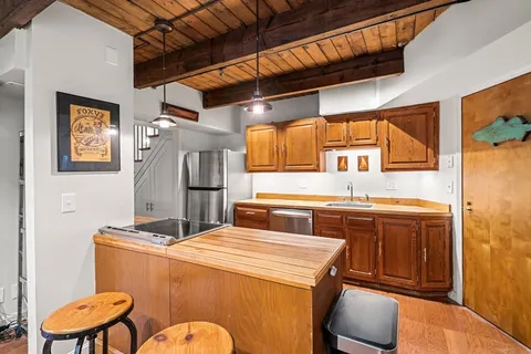 a kitchen that has a sink and a stove in it