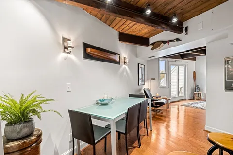 a view of a dining room with furniture and wooden floor