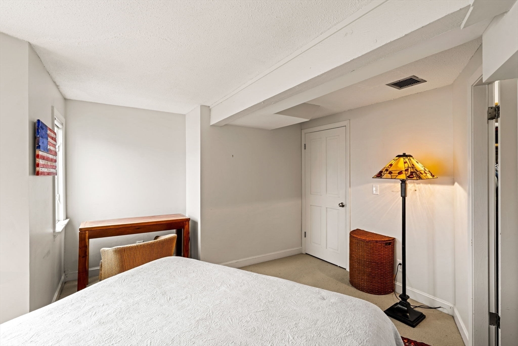 90 Wharf Street, Unit L10 Salem, MA 01970 - Photo 20 of 32 a bedroom with a bed and a desk