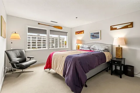 a spacious bedroom with a bed and a couch