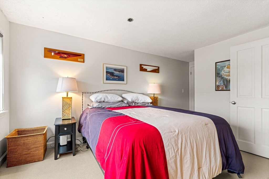 90 Wharf Street, Unit L10 Salem, MA 01970 - Photo 24 of 32 a bedroom with a bed and painting on the wall