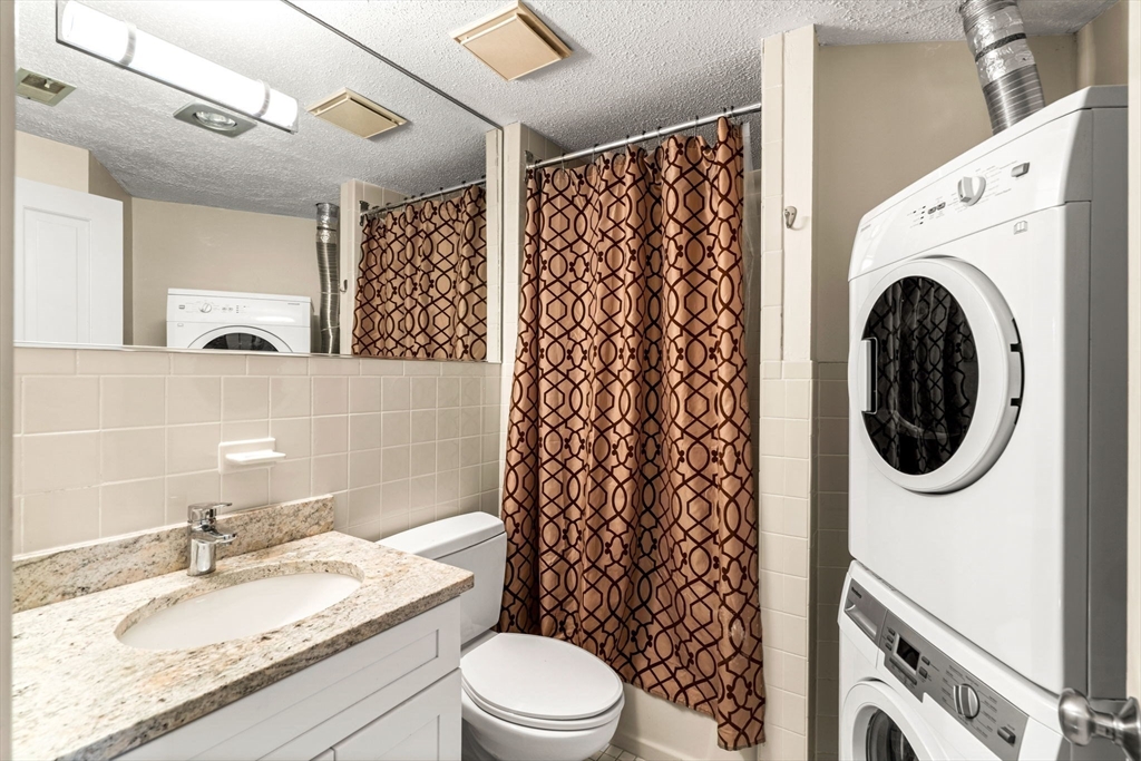 90 Wharf Street, Unit L10 Salem, MA 01970 - Photo 25 of 32 a bathroom with a granite countertop sink and a mirror