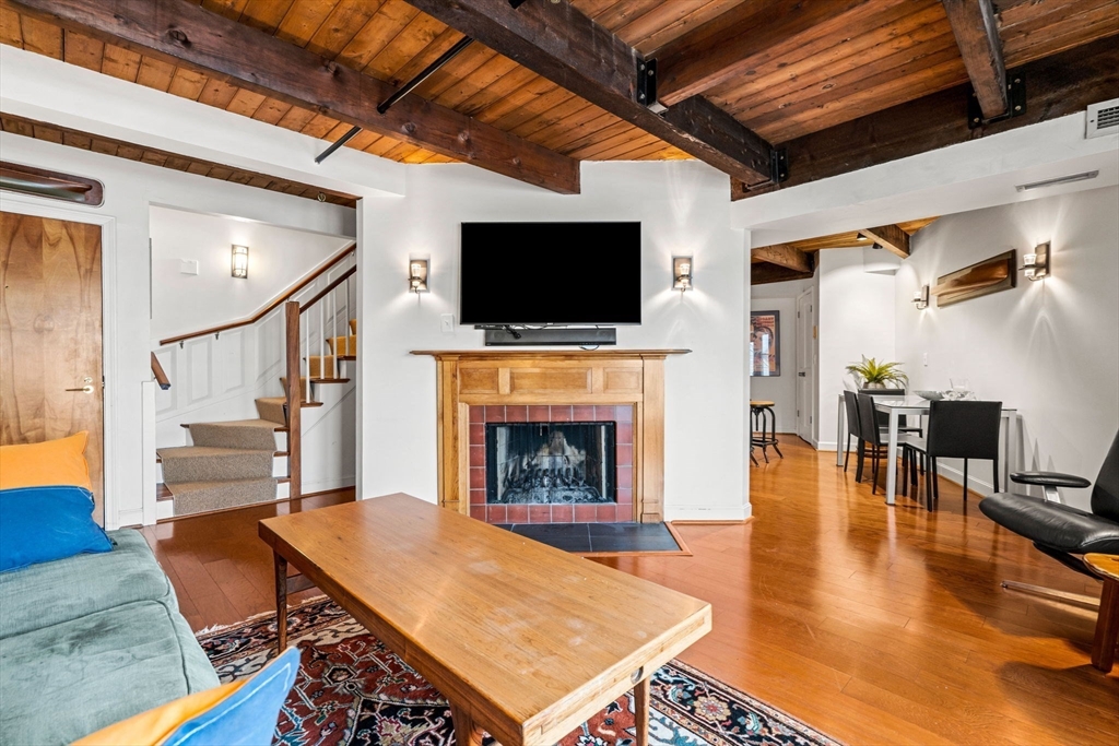 90 Wharf Street, Unit L10 Salem, MA 01970 - Photo 6 of 32 a living room with furniture a flat screen tv and a fireplace