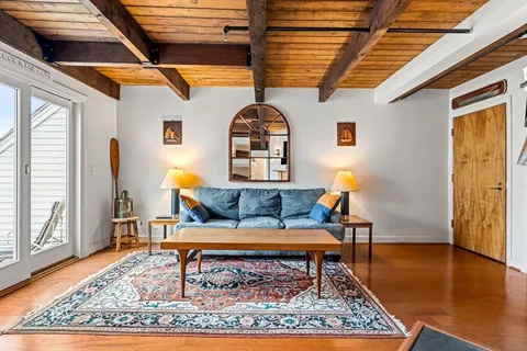 a living room with furniture and a rug