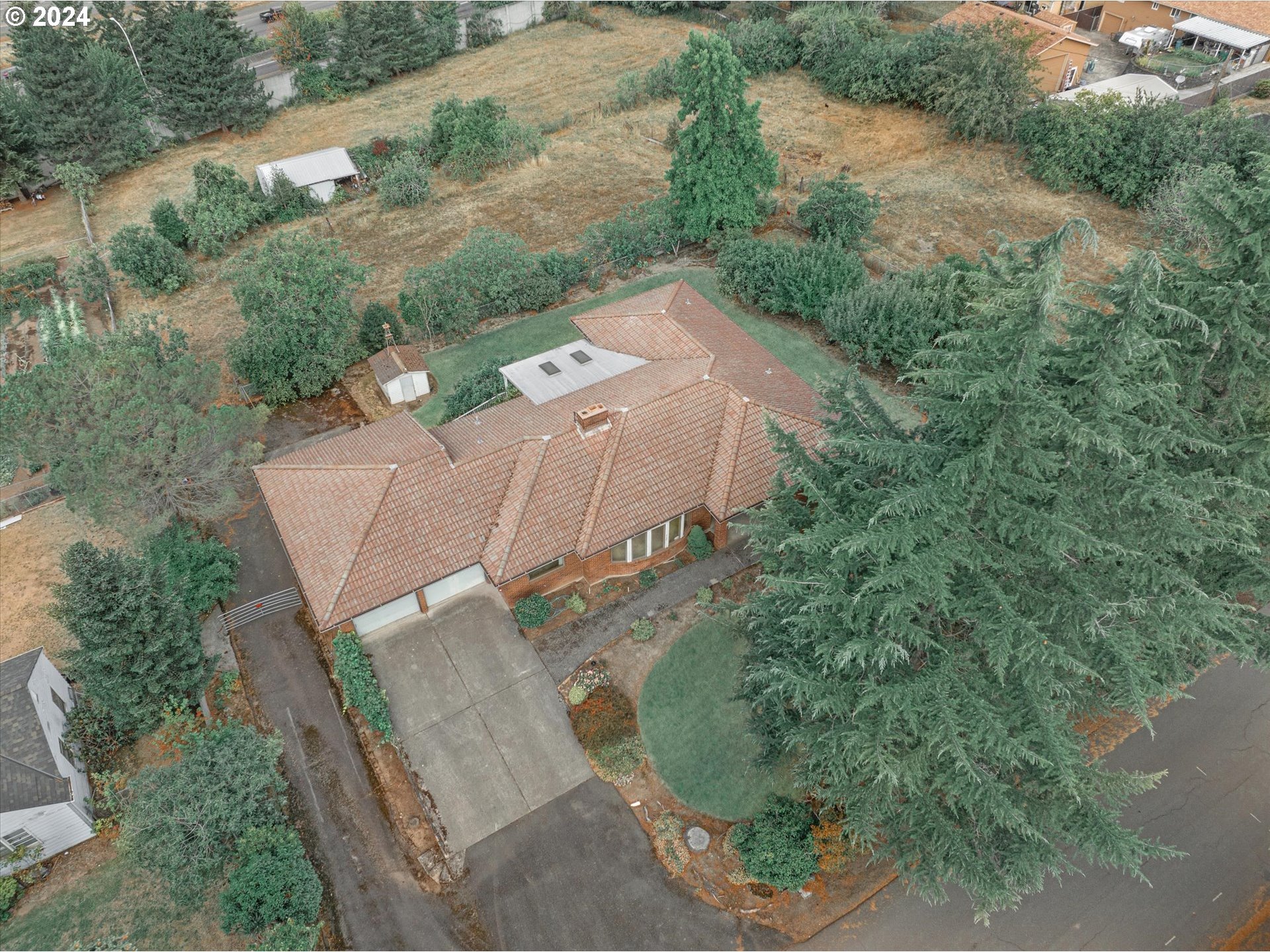 10755 Southeast 92nd Avenue Happy Valley, OR 97086 - Photo 32 of 40 an aerial view of a house with a yard and trees