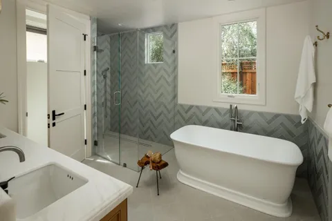 a white bath tub sitting next to a white sink