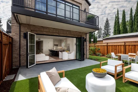 a view of a patio with couches chairs and a fire pit