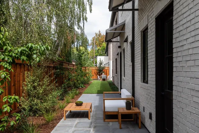 a backyard of a house with outdoor seating