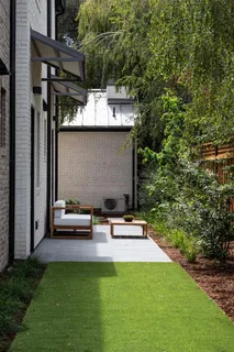 a backyard of a house with table and chairs