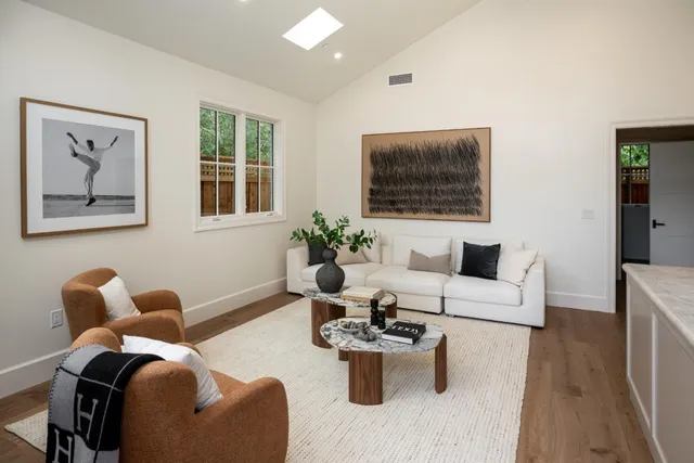 a living room with furniture potted plant and a window