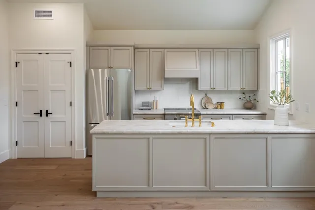 a kitchen with stainless steel appliances granite countertop a sink stove and refrigerator