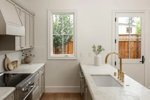 a kitchen with a sink stove and cabinets