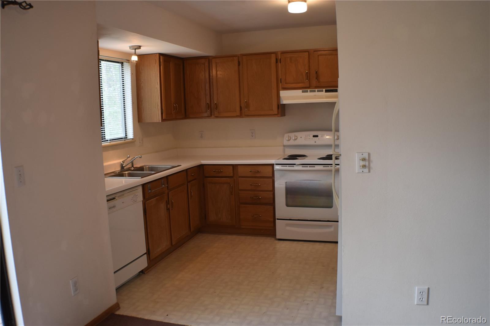 1322 Talley Circle Colorado Springs, CO 80904 - Photo 12 of 32 a kitchen with a stove sink and cabinets