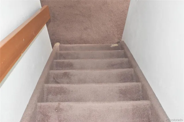 a view of staircase with white walls