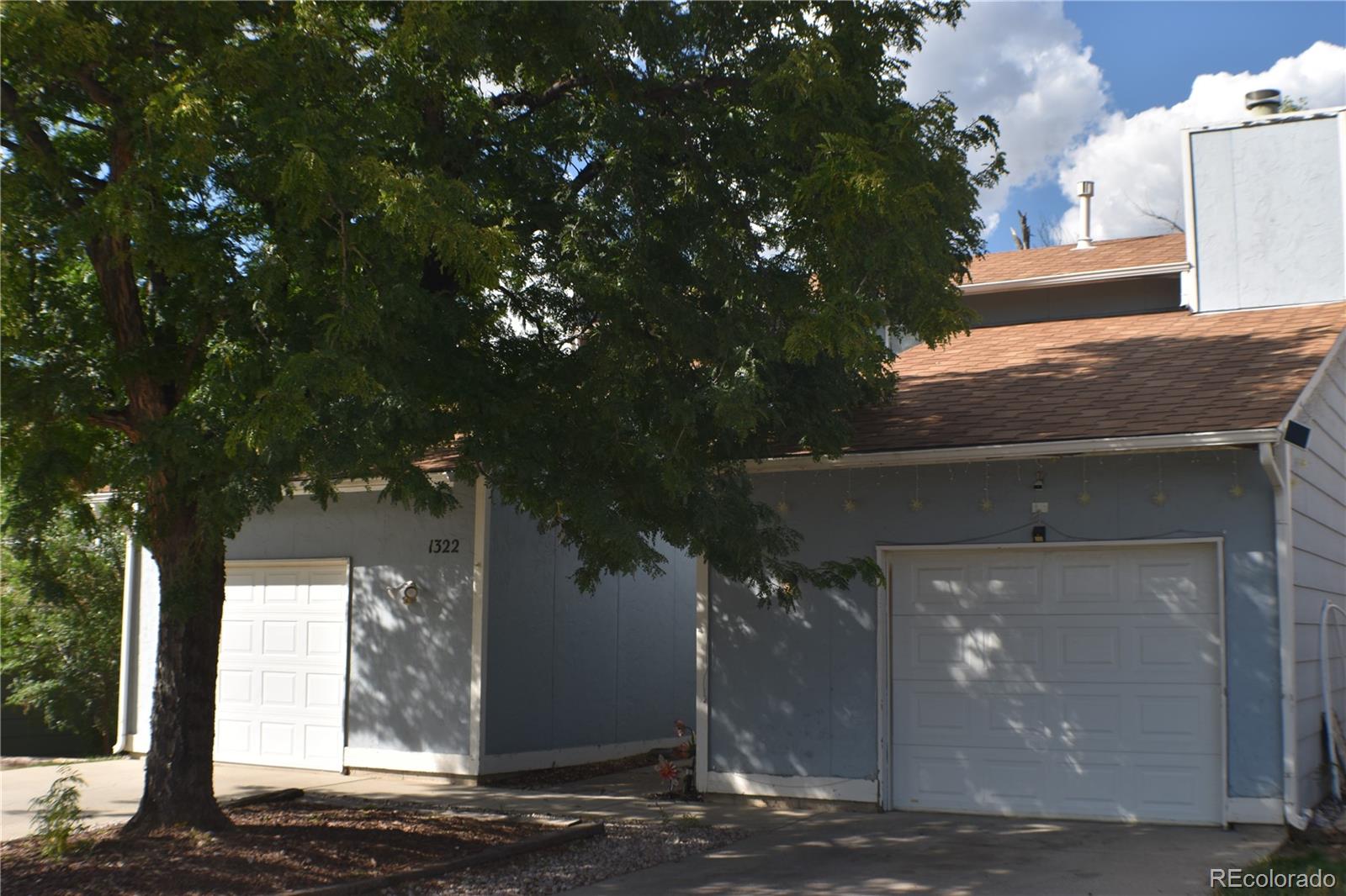 1322 Talley Circle Colorado Springs, CO 80904 - Photo 2 of 32 a front view of a house with trees